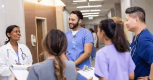 group of medical professionals discussing around a job board