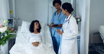 Two doctors speaking to patient about pain management