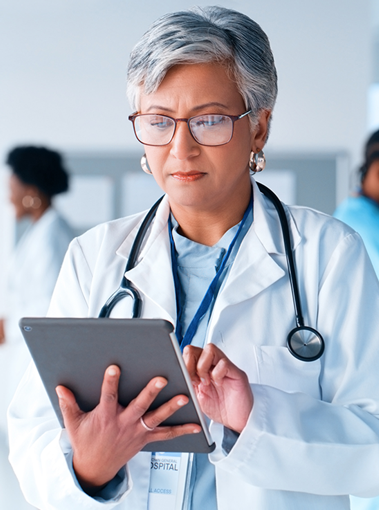 Female physician reviewing documentation on a smart tablet