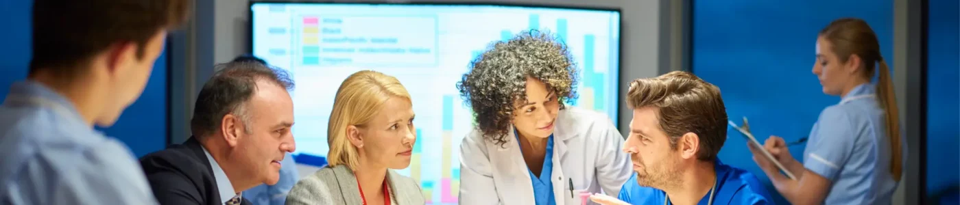 Hospital professionals discussing strategy in a meeting room, highlighting SCP Health’s healthcare core capabilities.